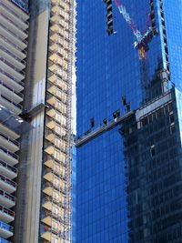 Low angle view of modern glass building in city