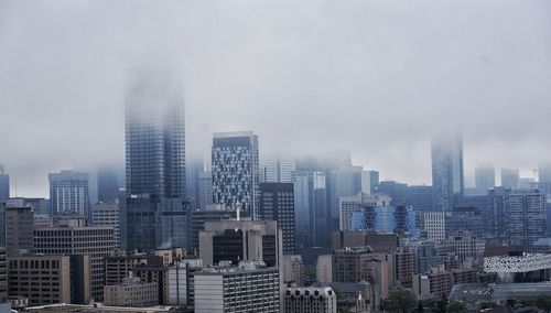 Modern buildings in city against sky