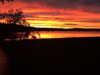 Scenic view of lake against orange sky