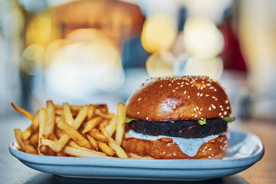 Close-up of burger and french fries in tray on table