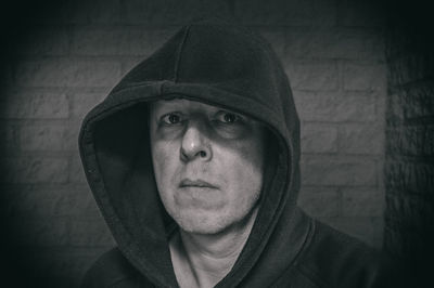 Close-up portrait of man wearing hooded jacket