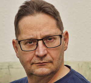 Close-up portrait of man wearing eyeglasses