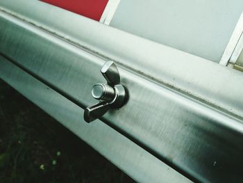 High angle view of key on railing