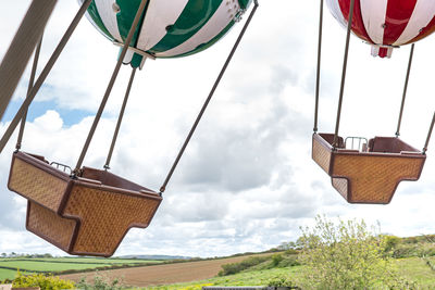 Low angle view of umbrellas on field against sky