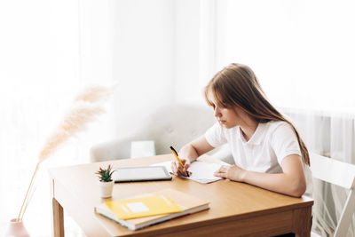 Young woman sitting on table