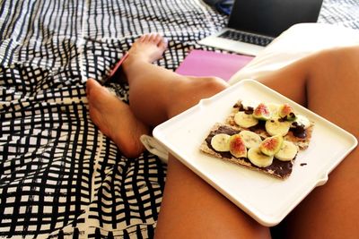 Breakfast on woman lap at home