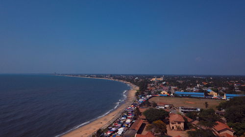 High angle view of sea and buildings against clear sky