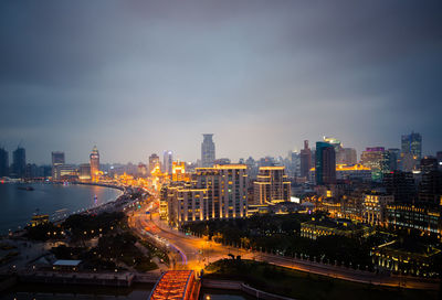 High angle view of illuminated buildings in city against sky