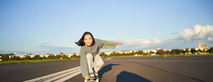 Rear view of woman standing against sky