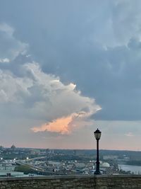 View of buildings in sea against cloudy sky