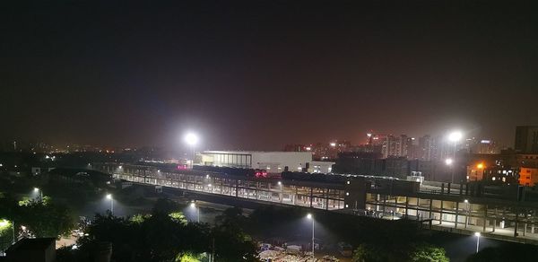 High angle view of illuminated buildings against sky at night