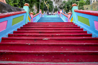 Rear view of women sitting on steps