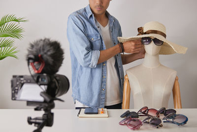Man photographing with camera on table