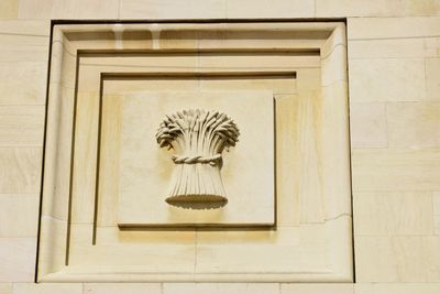 Low angle view of statue against wall