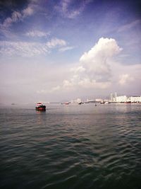 Boats sailing in sea against sky