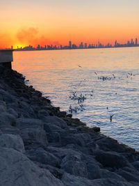 Scenic view of sea against orange sky