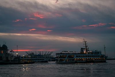 Boats in sea against sky during sunset