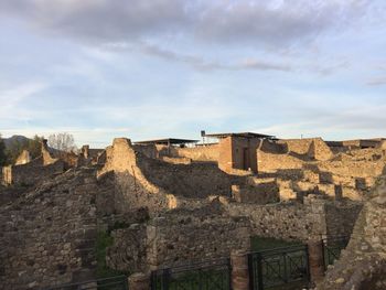 Ruins of building against cloudy sky