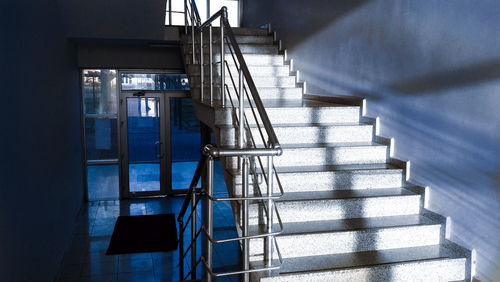 Empty staircase by railing at home