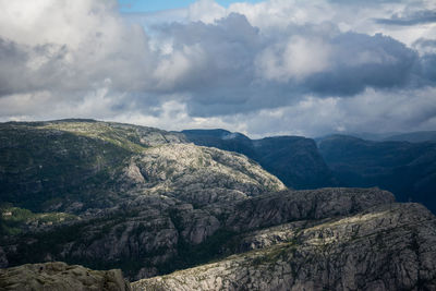 View of rocky mountain against cloudy sky