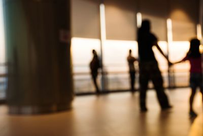 Silhouette people walking on floor