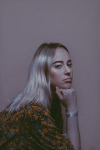 Portrait of woman against wall