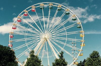 Low angle view of ferris wheel against sky