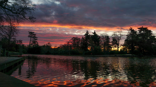 Scenic view of lake against romantic sky at sunset