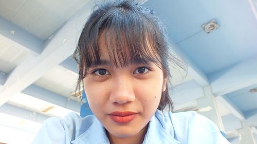 Close-up portrait of smiling teenage girl in school