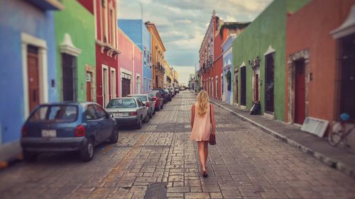 Woman walking on street in city