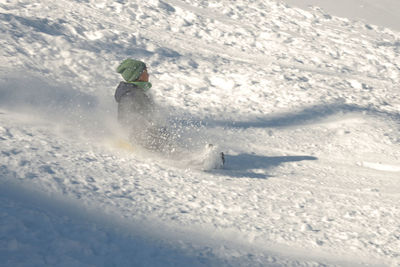 Person skiing on snow covered mountain