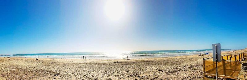 Scenic view of beach against clear sky