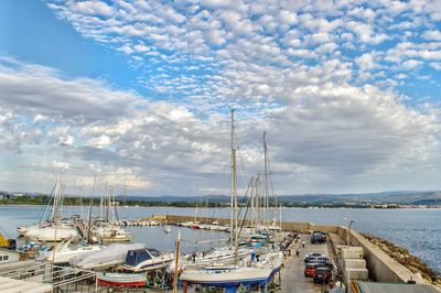 Sailboats moored in harbor