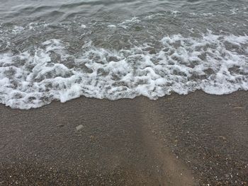 High angle view of waves rushing towards shore