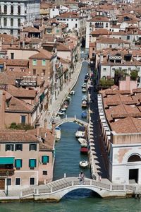 Narrow canal with multiple footbridges separates typical venetian residences