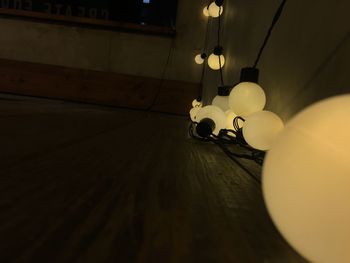 Low angle view of illuminated pendant light hanging on table at home