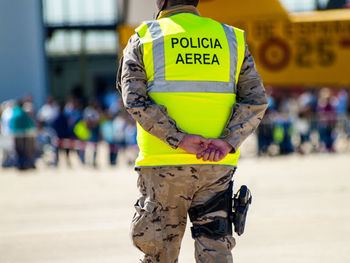 Midsection of man standing with text