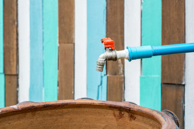 Water tap on wood background