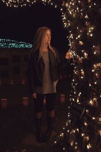 Young woman standing in the dark
