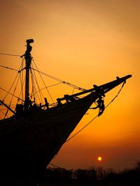 Silhouette of sailboat against sky during sunset