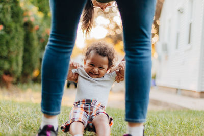 Midsection of mother and son standing outdoors