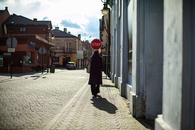 Rear view of woman walking on street