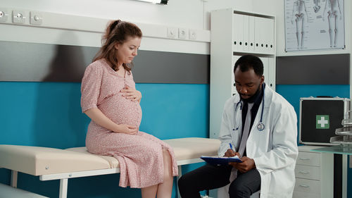 Female doctor examining x-ray at clinic