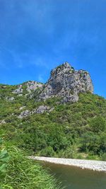 Scenic view of landscape against blue sky