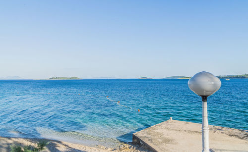 Scenic view of sea against clear blue sky