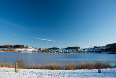 Scenic view of frozen lake against sky during winter