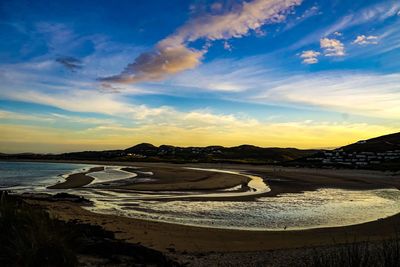 Scenic view of beach against sky during sunset