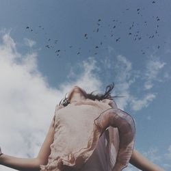 Low angle view of birds flying in sky