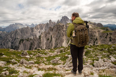 Photographer with telephoto lens in mountain landscape. man with mountain trekking