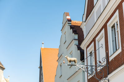 Low angle view of buildings against clear blue sky